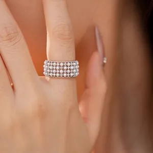 Elegant multi-layer pearl ring with sparkling zircon accents shown on a model finger