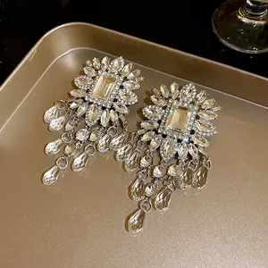 Close-up of luxury chandelier earrings featuring brilliant crystals and teardrop tassels.