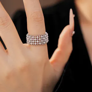 Exquisite close-up of a multi-layer round pearl and zircon ring with a vintage aesthetic