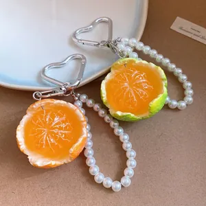 Realistic orange and lime slice phone charm with white pearl beads and silver heart-shaped clasp