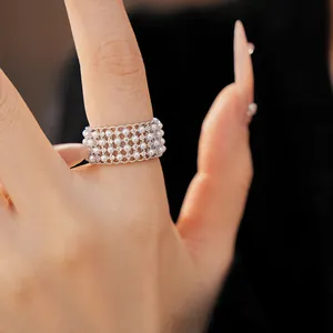 Elegant close-up showing the detail of a vintage multi-layer pearl and zircon mesh ring