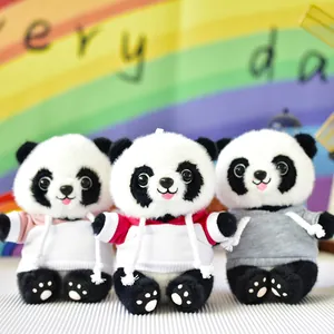 Close-up of three cute panda plush toys wearing colorful pink, red, and grey hoodies