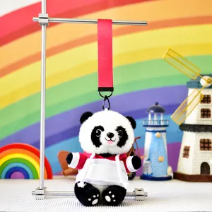 Close-up of cute panda plush toy wearing a hoodie with colorful lanyard attachment