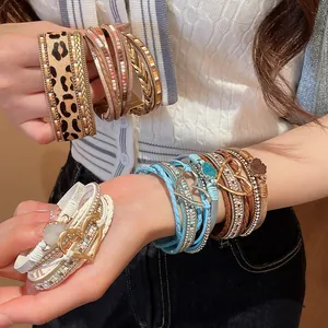 Macro view of bohemian multilayer leather braided bracelets with heart charms and magnets