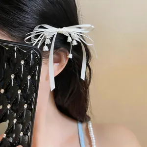 Vista dettagliata dell'elegante fermaglio per capelli a fiocco con mughetto