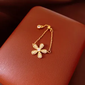 Detailed close-up of a vintage crystal flower chain ring on a luxury leather case