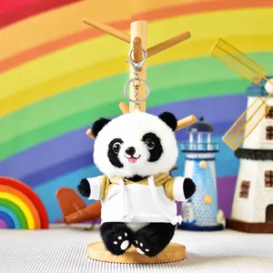 Close-up of cute plush panda keychain wearing a white hoodie with silver lobster clasp