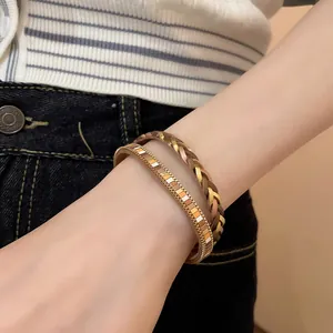Detailed close-up showing Bohemian braided leather and metallic magnetic bracelets on a wrist