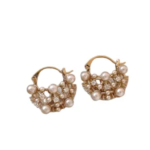 Elegant gold-plated hollow hoop earrings featuring shimmering pearls and crystal accents