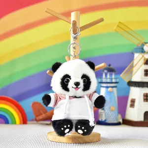 Detailed view of plush panda keychain wearing a pink hoodie with silver lobster clasp