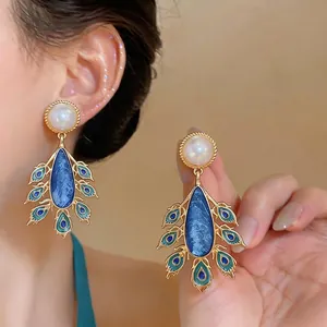 Elegant vintage peacock style drop earrings with white pearl and blue enamel