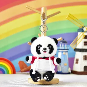 Close-up of panda plush keychain wearing red hoodie with silver lobster clasp