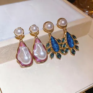 Vintage palace style pearl dangle earrings featuring irregular pink and elegant blue designs