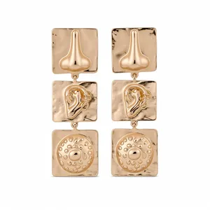 Artistic vintage gold square earrings featuring unique ear and nose relief patterns.