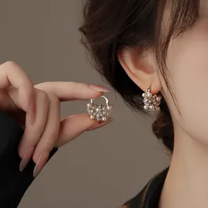 Detailed view of elegant pearl and crystal hollow hoop earrings worn on the ear