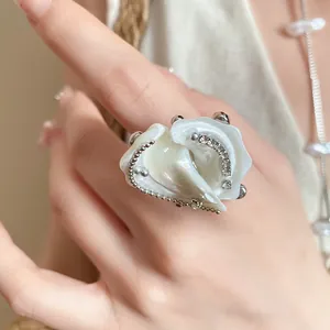 Detailed macro view of a unique beach style shell ring featuring pearls and crystals