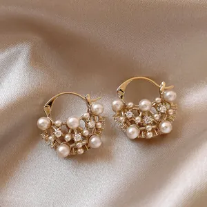 Elegant French vintage gold earrings with hollow pearl and rhinestone design details
