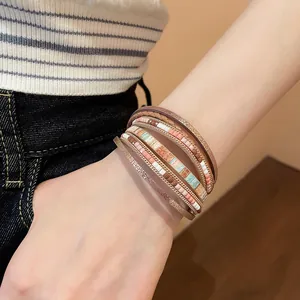 Close-up of bohemian multi-layer woven leather bracelet with magnetic clasp on wrist