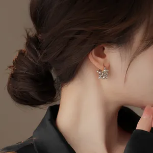 Detailed side view of elegant French vintage hollow pearl earrings worn by Asian model