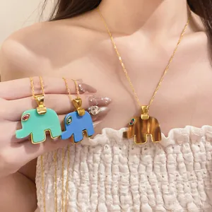 Close-up of elephant pendant necklaces in green, blue, and tiger eye resin with gold chains.