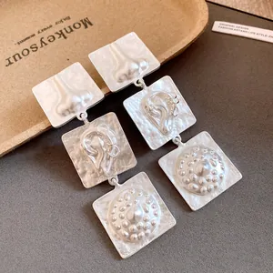 Artistic vintage matte silver square earrings featuring unique human facial feature reliefs
