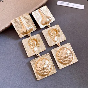 Retro gold square drop earrings featuring unique artistic facial feature reliefs