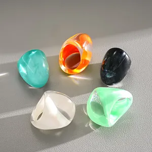 Close-up detail of vintage style chunky resin rings in multiple vibrant color finishes