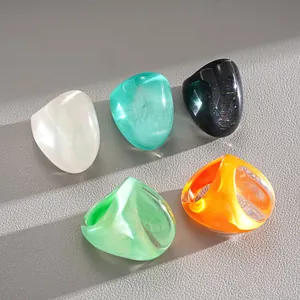 Macro detail of colorful exaggerated resin rings with vintage marbled texture view