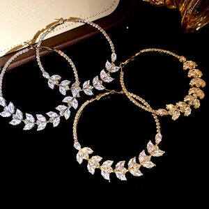 Close-up view of sparkling zircon wheat leaf patterns on elegant large hoop earrings