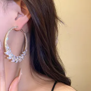 Exquisite zircon wheat ear hoop earring shown in detail on a model's ear with soft lighting