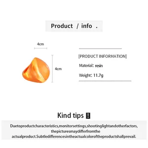 Detailed view of orange resin fan-shaped ring with size and material information