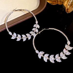 Detailed macro view of marquise cubic zirconia leaf pattern on elegant silver-plated hoop earrings