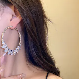 Detail of large hoop earrings with sparkling marquise-cut zircon wheat ear pattern