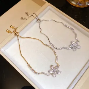 Elegant silver and gold tone bracelets with zircon flower pendants for women fashion