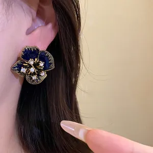 Elegant vintage navy blue enamel flower stud earrings with sparkling rhinestone accents