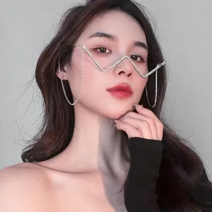 Close-up of model wearing unique rhinestone-encrusted W-shaped glasses frame with tassels