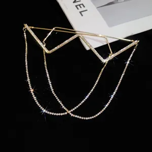 Detailed view of golden W-shaped frame glasses featuring rhinestones and long tassels