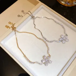 Macro detail of the sparkling zircon-encrusted flower charm on adjustable bracelet
