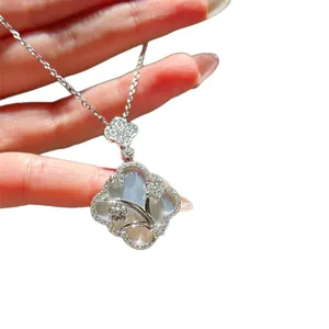 Elegant mother of pearl quatrefoil necklace with intricate floral pattern in silver