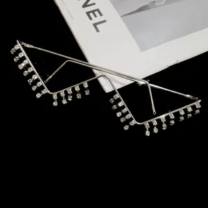 Close-up of W-shaped decorative silver glasses frame with dangling rhinestone tassels detail.