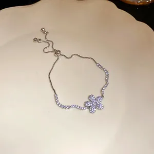 Macro view of silver flower bracelet with sparkling zircon stones and adjustable clasp