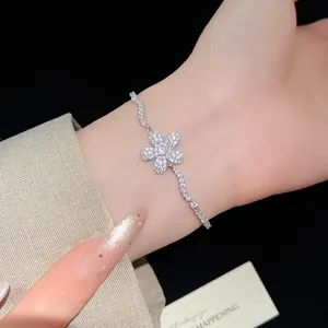 Close-up detail of sparkling zircon flower pendant bracelet elegantly worn on wrist