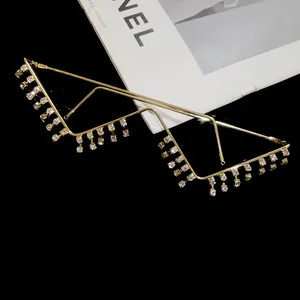 Detail of gold W-shaped lensless glasses with dangling rhinestone tassels for women.