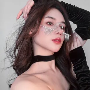 Close-up of trendy W-shaped rhinestone glasses frame with fringe tassel decor