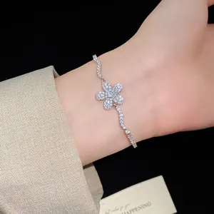 Macro detail of a sparkling zircon flower pendant bracelet with wavy diamond chain