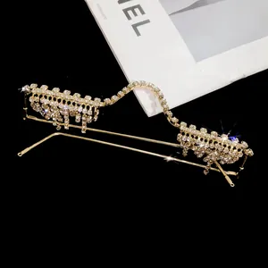 Detail showing the intricate rhinestone-studded W-shaped frame with elegant tassel drops