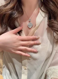 Elegant white mother-of-pearl window-grille pendant necklace shown on a model's neck