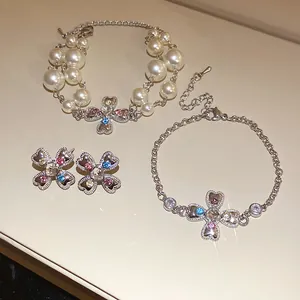 Macro detail of vintage court style heart cross flower bracelets and earrings set with crystals