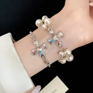 Close-up of vintage heart cross flower bracelets with colorful rhinestones and pearls