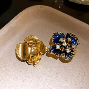 Detailed view showing the front and back of vintage blue enamel flower stud earrings